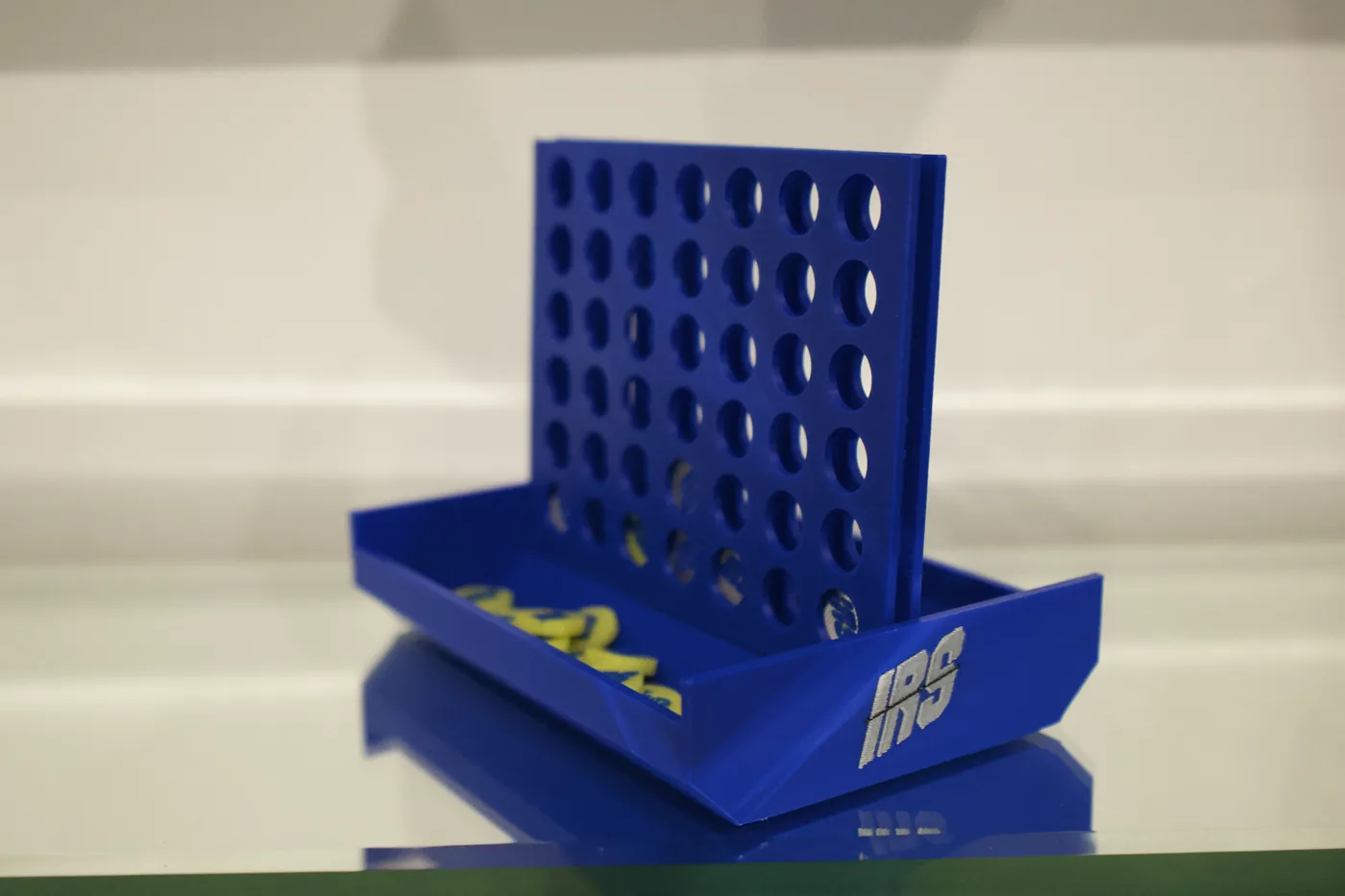 Branded blue Connect 4 game with IRS logo